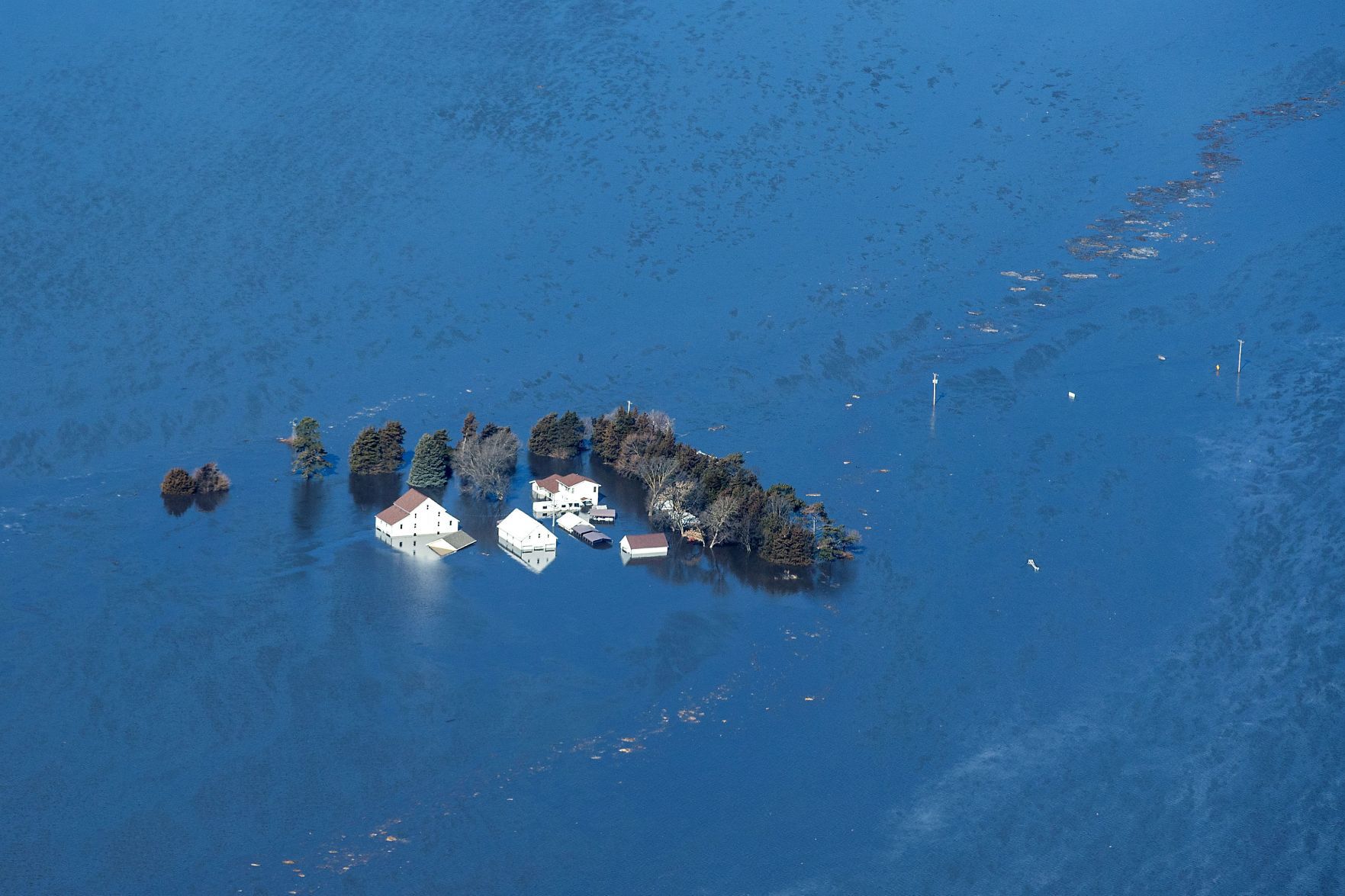 A house is surrounded by floodwaters near Waterloo, Nebraska, on Friday.